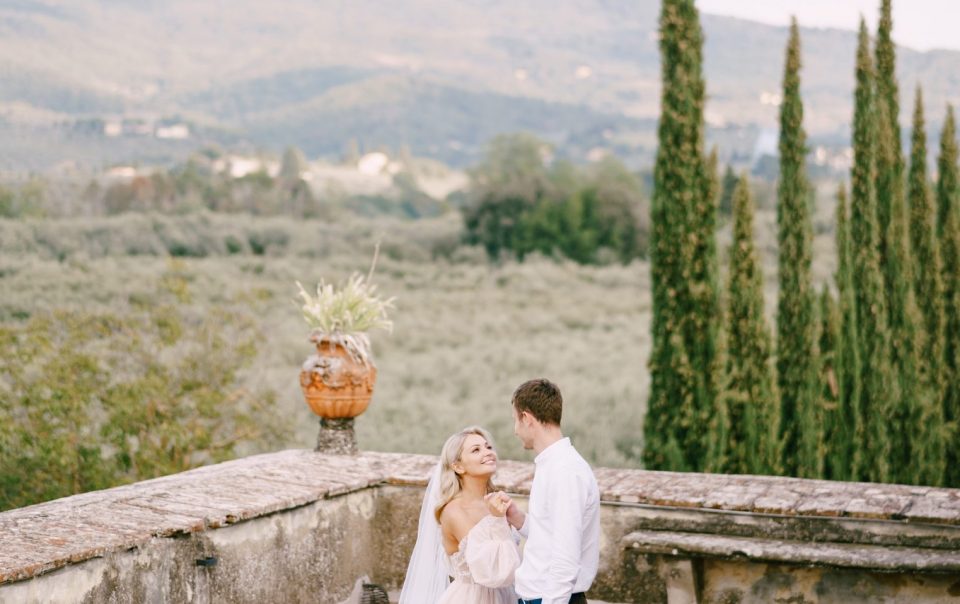 The bride and groom dancing on the roof of the old winery villa in Tuscany