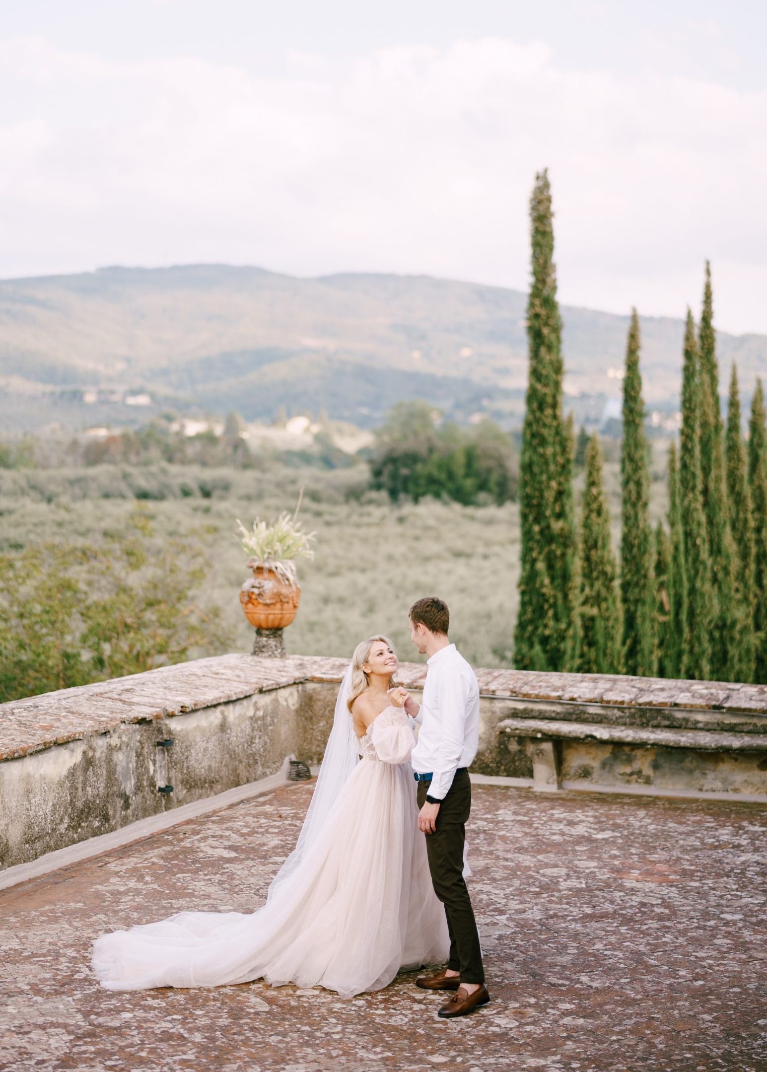 The bride and groom dancing on the roof of the old winery villa in Tuscany