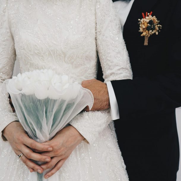 Married couple holding a white tulips bouquet