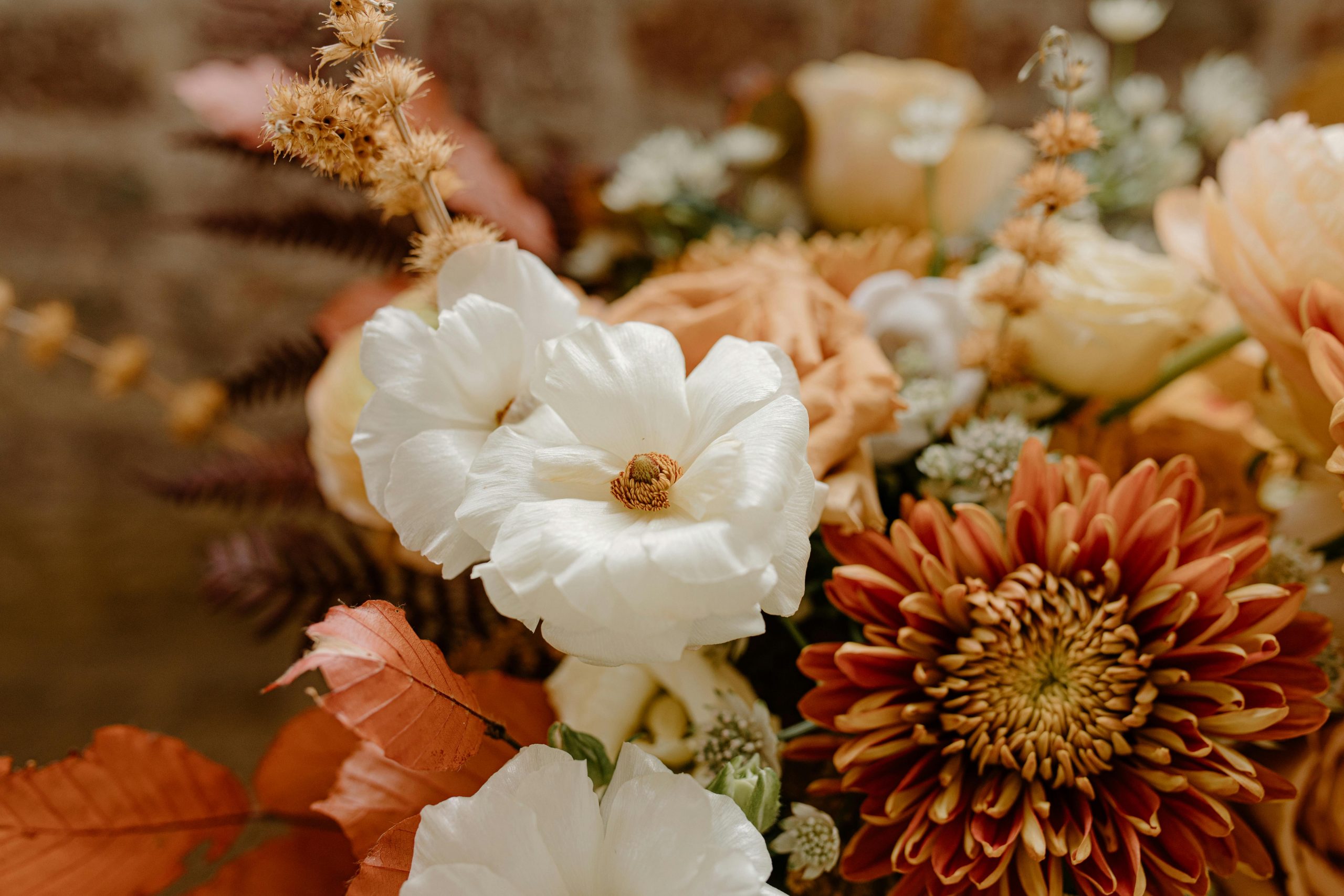 Vibrant autumn bouquet in orange, brown and white